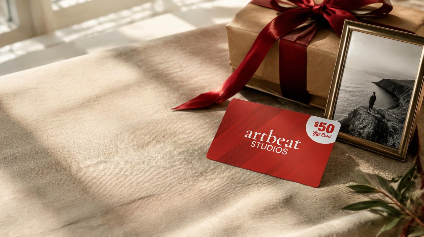 ArtBeat Studios gift card beside a wrapped gift and framed print